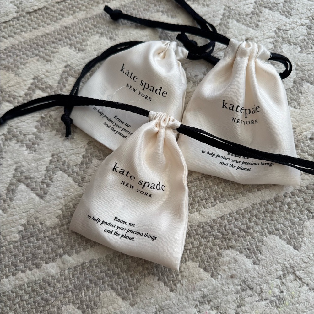 Kate Spade Cream Drawstring Pouches